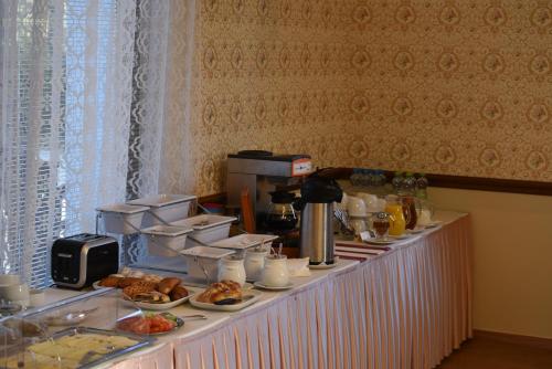 a buffet with breakfast foods on a table at Villa Žerotín Penzion Bed & Breakfast in Velké Losiny