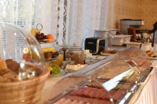 a counter top with a bunch of food on it at Villa Žerotín Penzion Bed & Breakfast in Velké Losiny