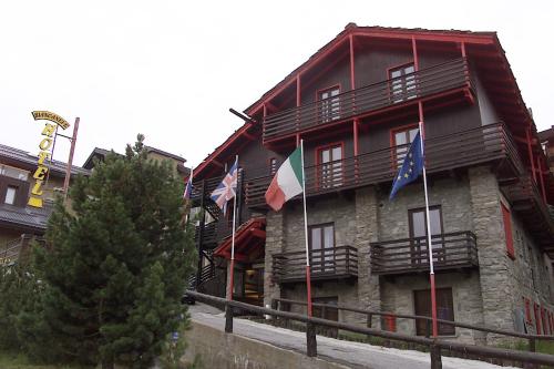 a building with flags on the side of it at Hotel Biancaneve in Sestriere