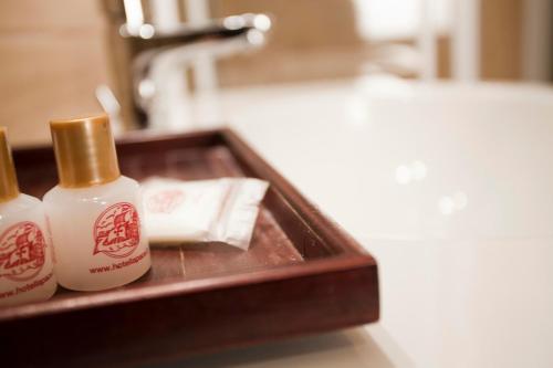 a bathroom with two bottles of soap and a sink at Hotel La Pace in Pisa