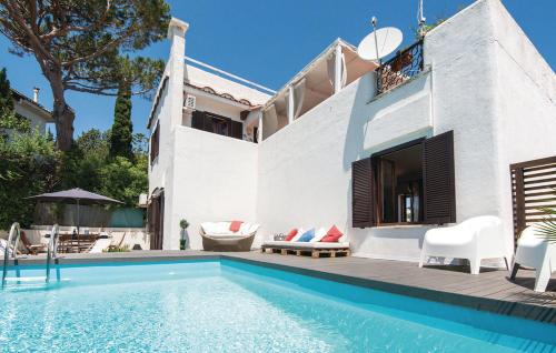 a white house with a swimming pool in front of it at GAETA - Villa Fontania in Gaeta