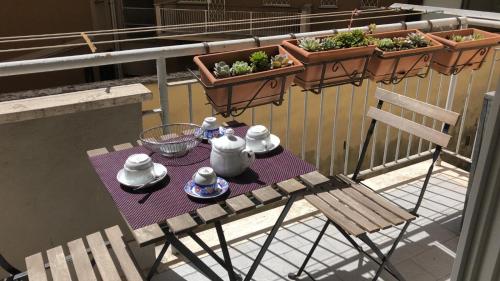 a table and chairs with pots of plants on a balcony at L'Angolo Di San Pietro in Rome