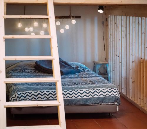 a bedroom with a bunk bed and a ladder at PEDRA DOS CORVOS Beach House in Odeceixe