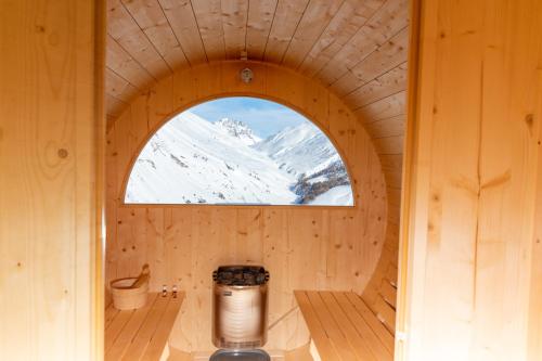 an inside view of a wooden room with a window at Pianeta Oro Apartments in Livigno