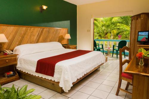 A bed or beds in a room at Legends Beach Resort