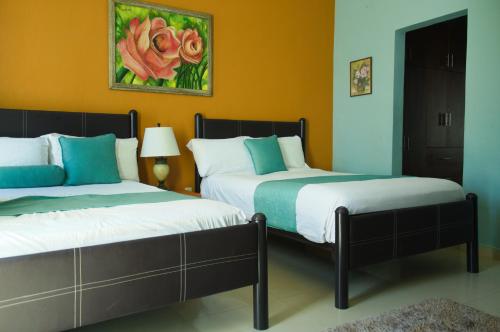 two beds sitting next to each other in a room at Casa las Flores in Puerto Vallarta