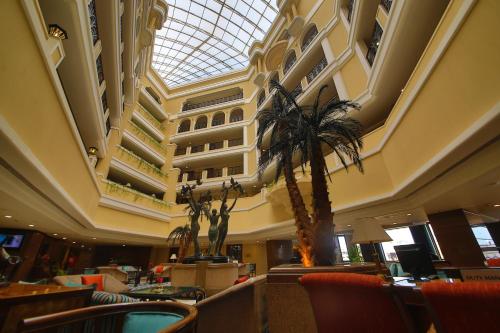 eine Lobby mit einer Palme und einem Gebäude in der Unterkunft Welcomhotel by ITC Hotels, Devee Grand Bay, Visakhapatnam in Visakhapatnam