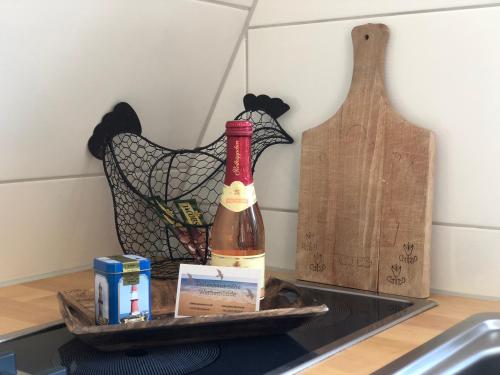 a bottle of wine on a tray on a kitchen counter at Ferienhaus nähe Warnemünde in Elmenhorst