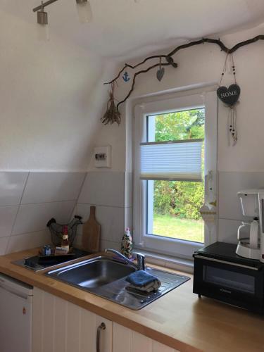 a kitchen with a sink and a window at Ferienhaus nähe Warnemünde in Elmenhorst