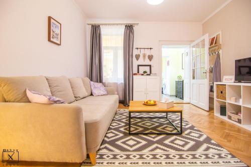 a living room with a couch and a coffee table at Via Del Centro in Sibiu