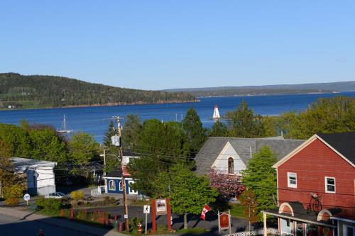 an aerial view of a small town with a lake at Telegraph House Motel in Baddeck