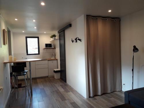 Habitación con puerta corredera en una cocina con encimera en Studio avec jardin et stationnement gratuit à Rouen, en Rouen