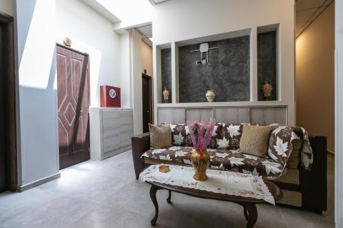 a living room with a couch and a table at Amalia City Rooms in Chios