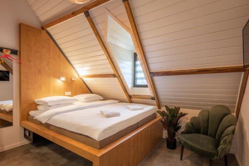 a bedroom with a bed and a chair in a room at Bunk Hotel Utrecht in Utrecht