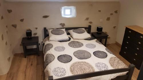 a bedroom with a bed with two tables and a window at Gite de la Haie in Apremont