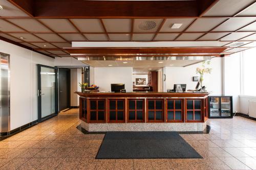 a lobby with a reception desk in a building at Thon Partner Hotel Victoria Hamar in Hamar