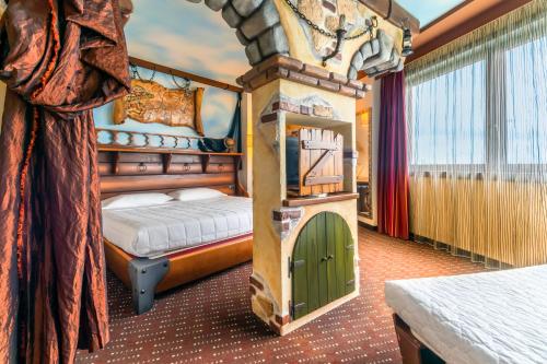 a bedroom with a bed and a tower in it at Grand Hotel Mattei in Ravenna