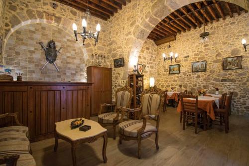 een restaurant met tafels en stoelen in een stenen muur bij D'Argento Boutique Rooms in Rhodos-stad