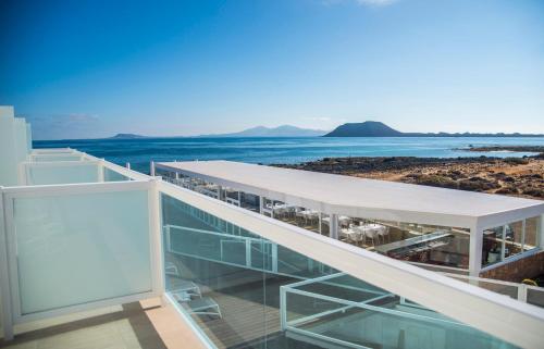 a building with a view of the ocean at Hotel Boutique TAO Caleta Mar in Corralejo