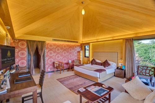 a bedroom with a bed and a living room at Aamby Valley City in Lonavala