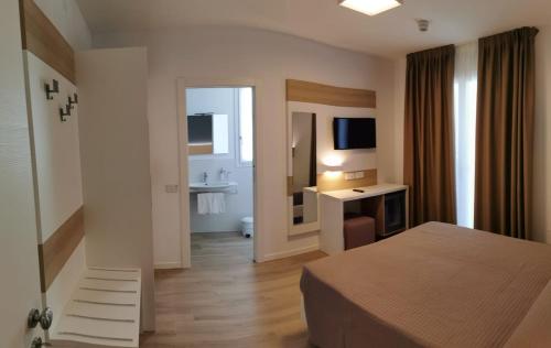 A bed or beds in a room at Almalux Jesolo Wellness & Spa 3 stelle superior