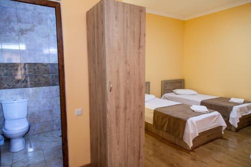 A bed or beds in a room at Hotel Old Borjomi