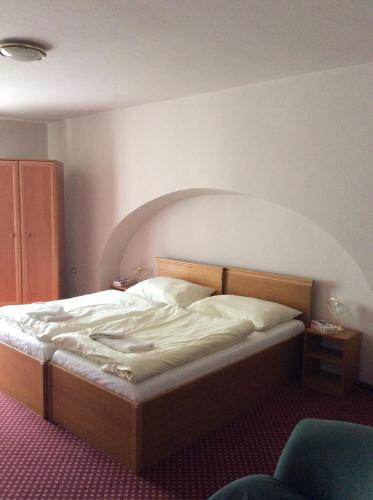 a bedroom with a bed in a room at Hotel U Zlateho Andela in Pardubice