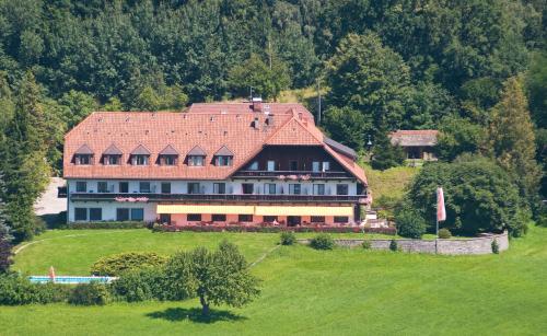 a large house with a red roof on a hill at Hotel Schöne Aussicht in Salzburg