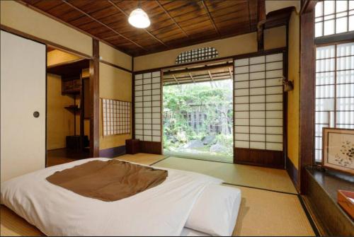 A bed or beds in a room at Guest House Koiya