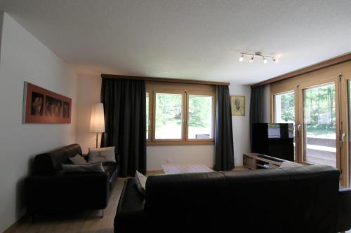 a living room with a couch and a window at Mischi 5 in Saas-Fee