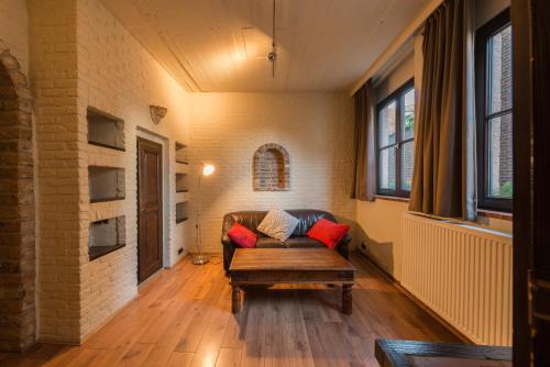 a living room with a couch and a table at City Flats by Lybeer Hotel Group in Bruges