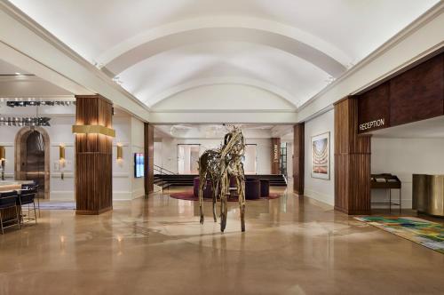 a sculpture of a giraffe in a lobby at Saint Kate - The Arts Hotel in Milwaukee