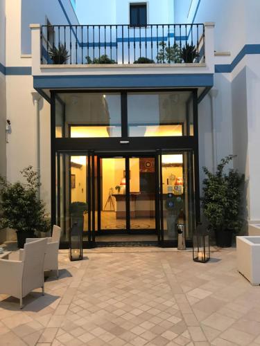 a large glass building with a balcony on top of it at Hotel Miramare in Otranto