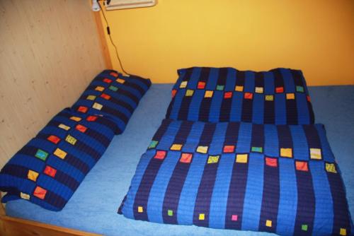 een bed met twee blauwe lakens met lego erop bij Penzion W in Pilsen