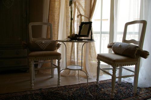 a room with two chairs and a table and a window at Serapo Bed and Breakfast in Gaeta