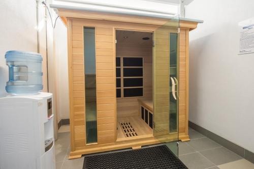 a small wooden enclosure in a room with a water cooler at Centrepoint Apartments Caloundra in Caloundra