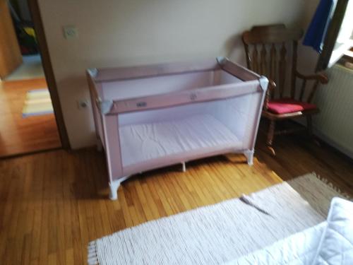 a pink dresser in a room with a chair at Apartment Sopar in Škofja Loka