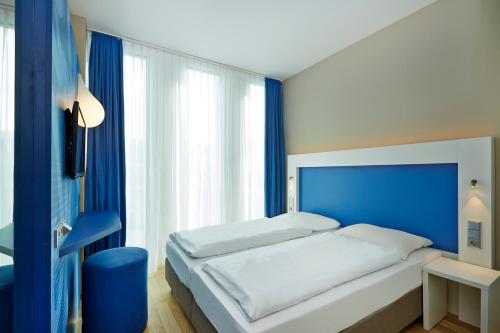 Ліжко або ліжка в номері H2 Hotel München Messe