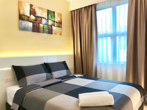 a bedroom with a blue and white bed with a window at RIVERO BOUTIQUE HOTEL Seremban 2 in Seremban