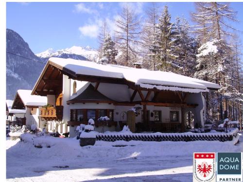 a house with snow on the roof of it at Gästehaus Sissy in Längenfeld