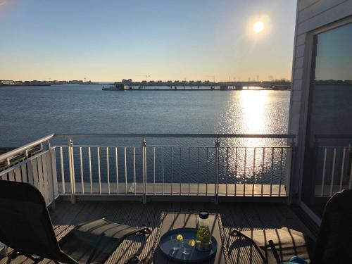 a balcony with a view of the water at Schleivilla Hafenmeister in Kappeln