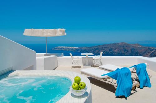 a villa with a pool and a table and chairs at White Santorini in Imerovigli