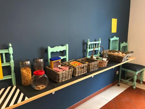 a shelf with baskets of food on a wall at Hostel 2300 Thomar in Tomar