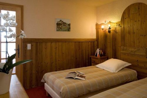 a bedroom with a bed with a book on it at Résidence Le Portillo in Val Thorens