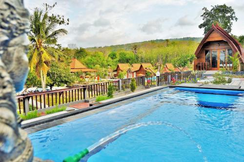 珀尼达岛Surya Chandra Beach Bungalow的房屋前的游泳池