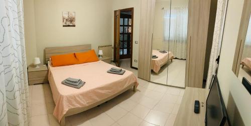 a bedroom with a bed and a mirror at 32 in Ciampino