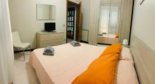 a bedroom with a bed and a television and a chair at 32 in Ciampino