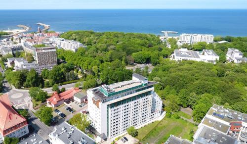 una vista aérea de una ciudad con árboles y el océano en Apartamenty Proeko Polonia, en Kołobrzeg