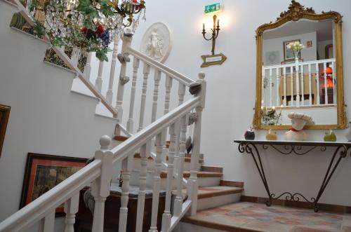 a stairwell with a mirror and a white staircase at A La Villa Boucicaut in Chalon-sur-Saône