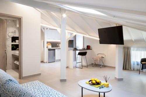 a white living room with a couch and a table at Thess Residences in Thessaloniki